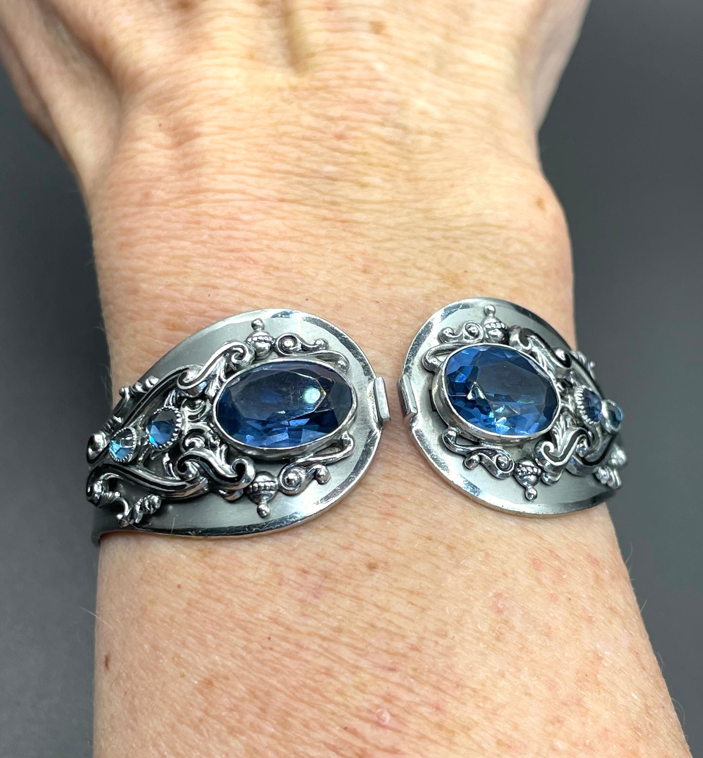 Vintage Neiger brothers sapphire blue rhinestone ornate Art Deco hinged clamper bangle set in silver tone with black enamel accents