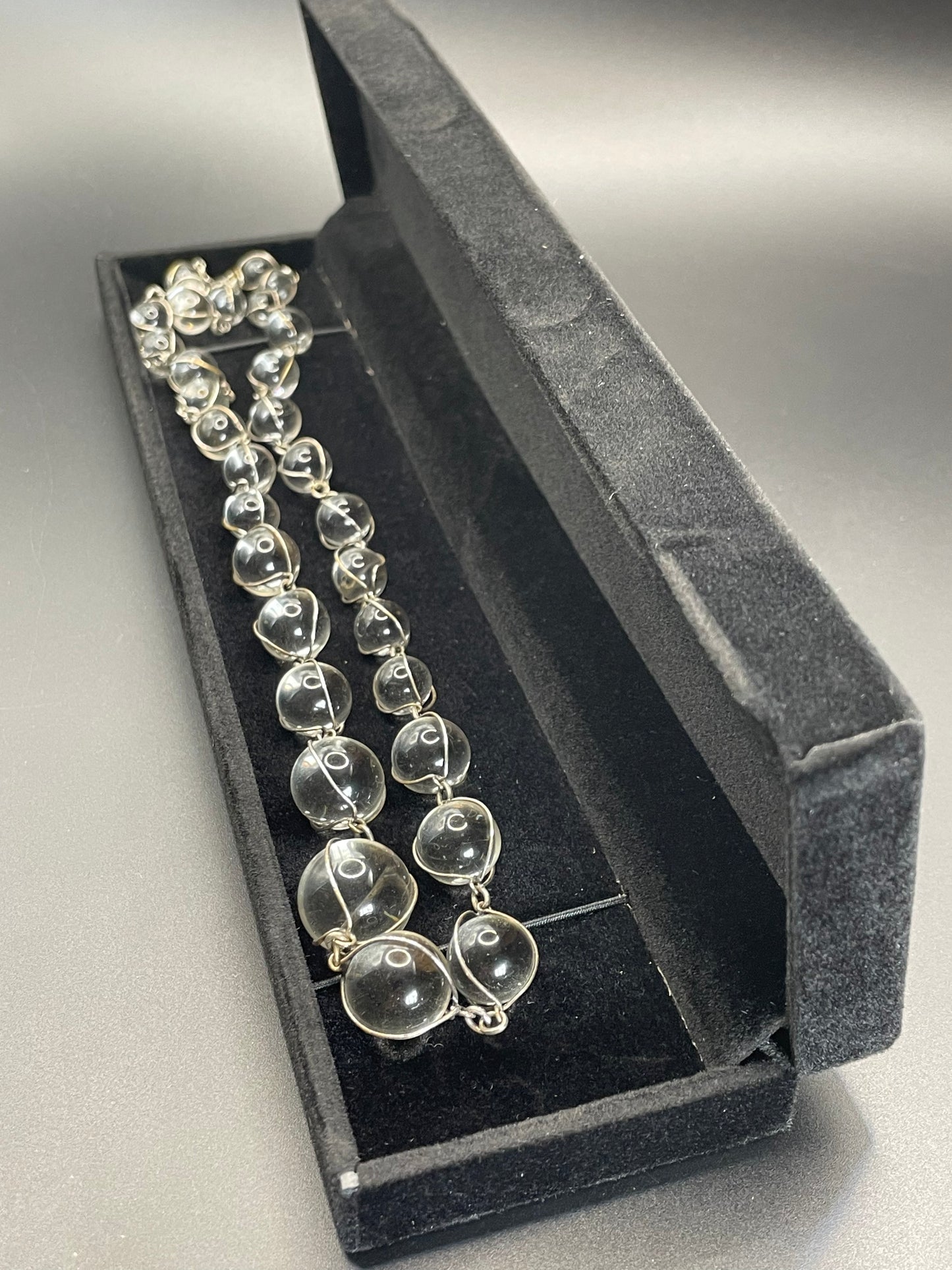 Antique 'pools of light' longer length necklace with undrilled rock crystal orbs in silver tone wire cage settings
