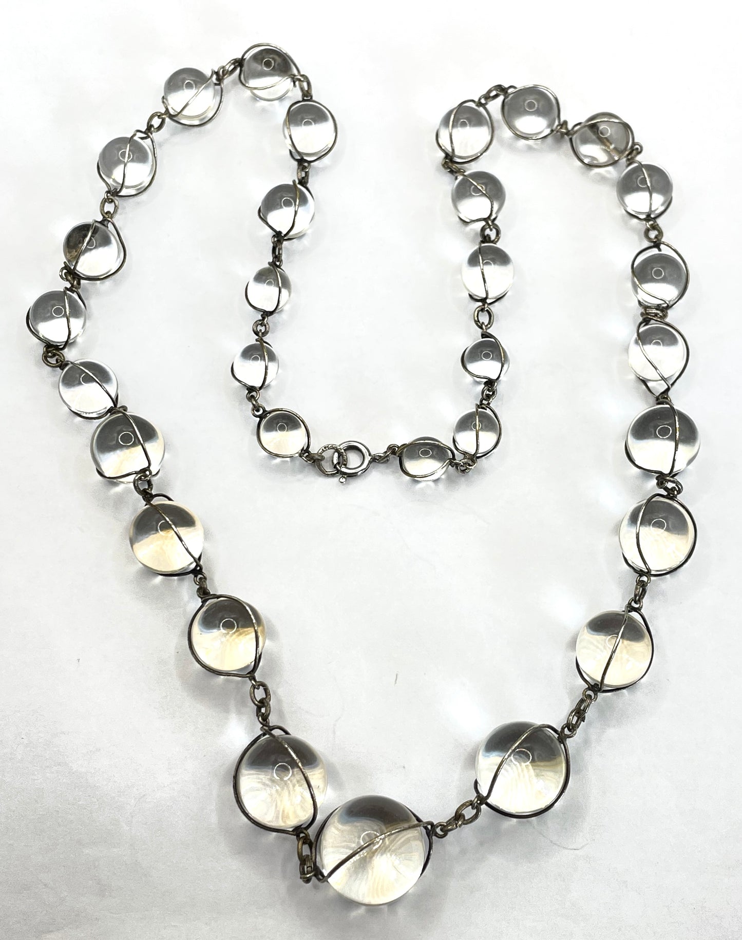 Antique 'pools of light' longer length necklace with undrilled rock crystal orbs in silver tone wire cage settings