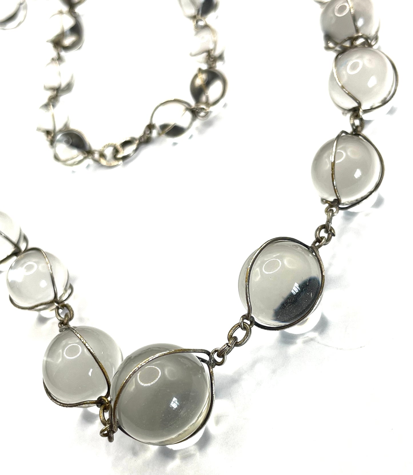 Antique 'pools of light' longer length necklace with undrilled rock crystal orbs in silver tone wire cage settings