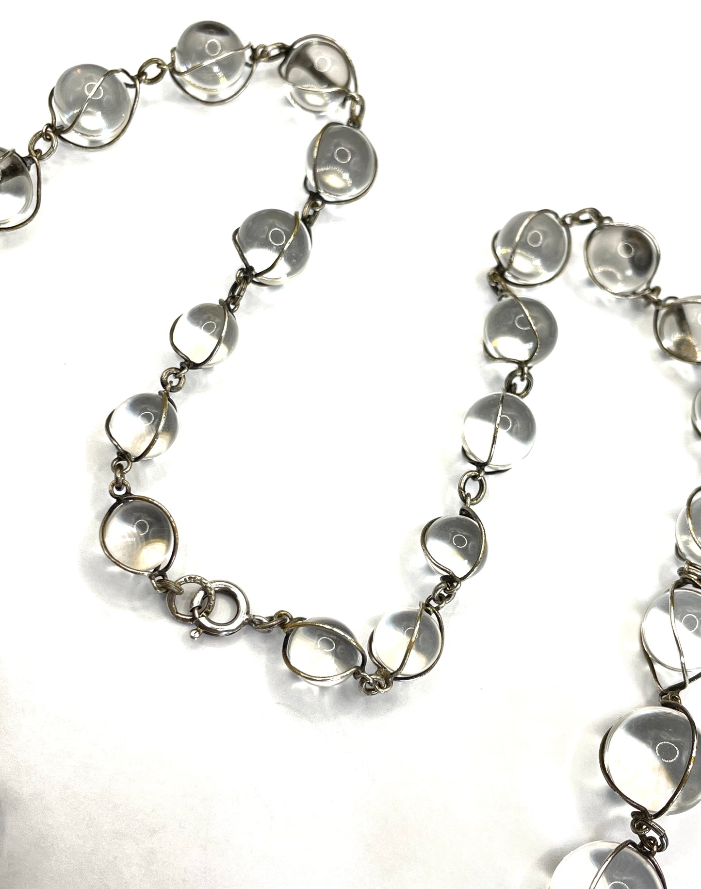 Antique 'pools of light' longer length necklace with undrilled rock crystal orbs in silver tone wire cage settings