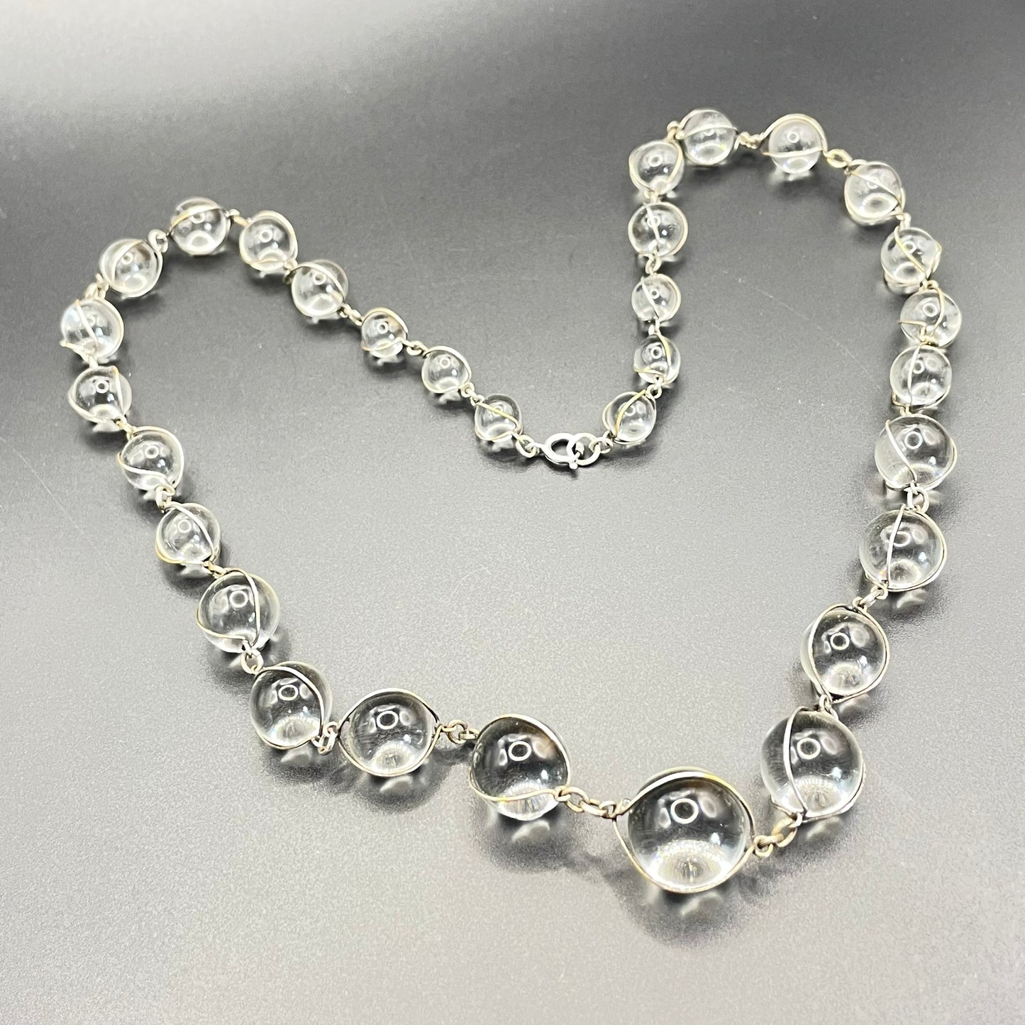 Antique 'pools of light' longer length necklace with undrilled rock crystal orbs in silver tone wire cage settings