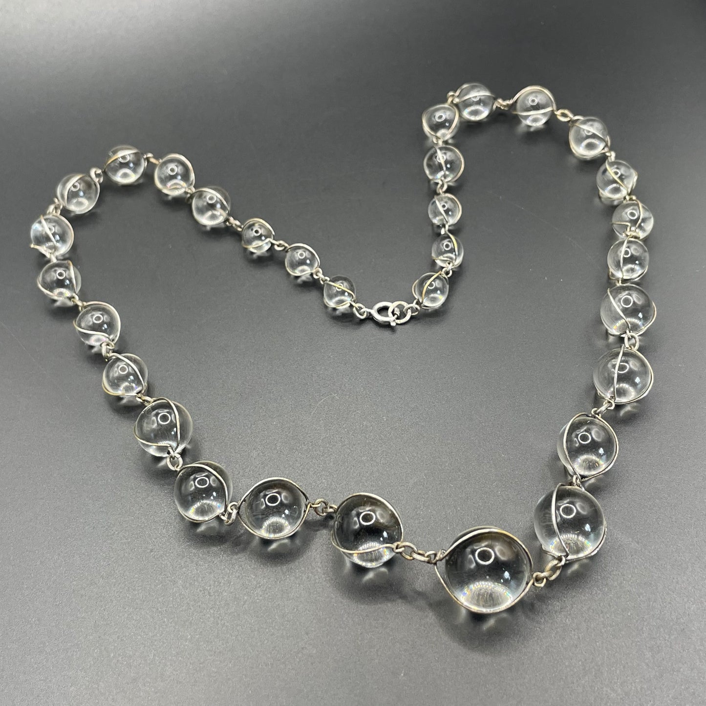 Antique 'pools of light' longer length necklace with undrilled rock crystal orbs in silver tone wire cage settings