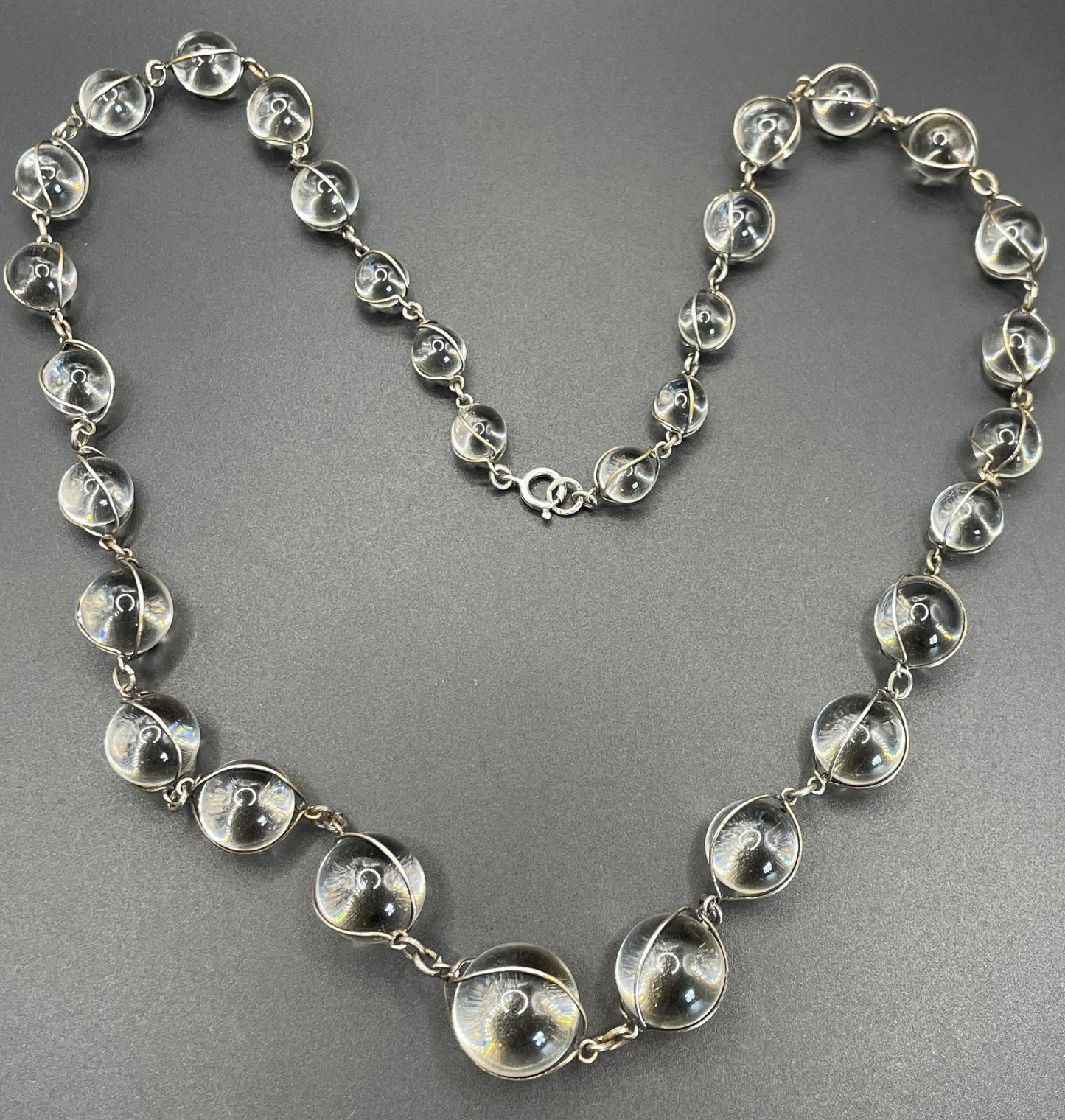 Antique 'pools of light' longer length necklace with undrilled rock crystal orbs in silver tone wire cage settings