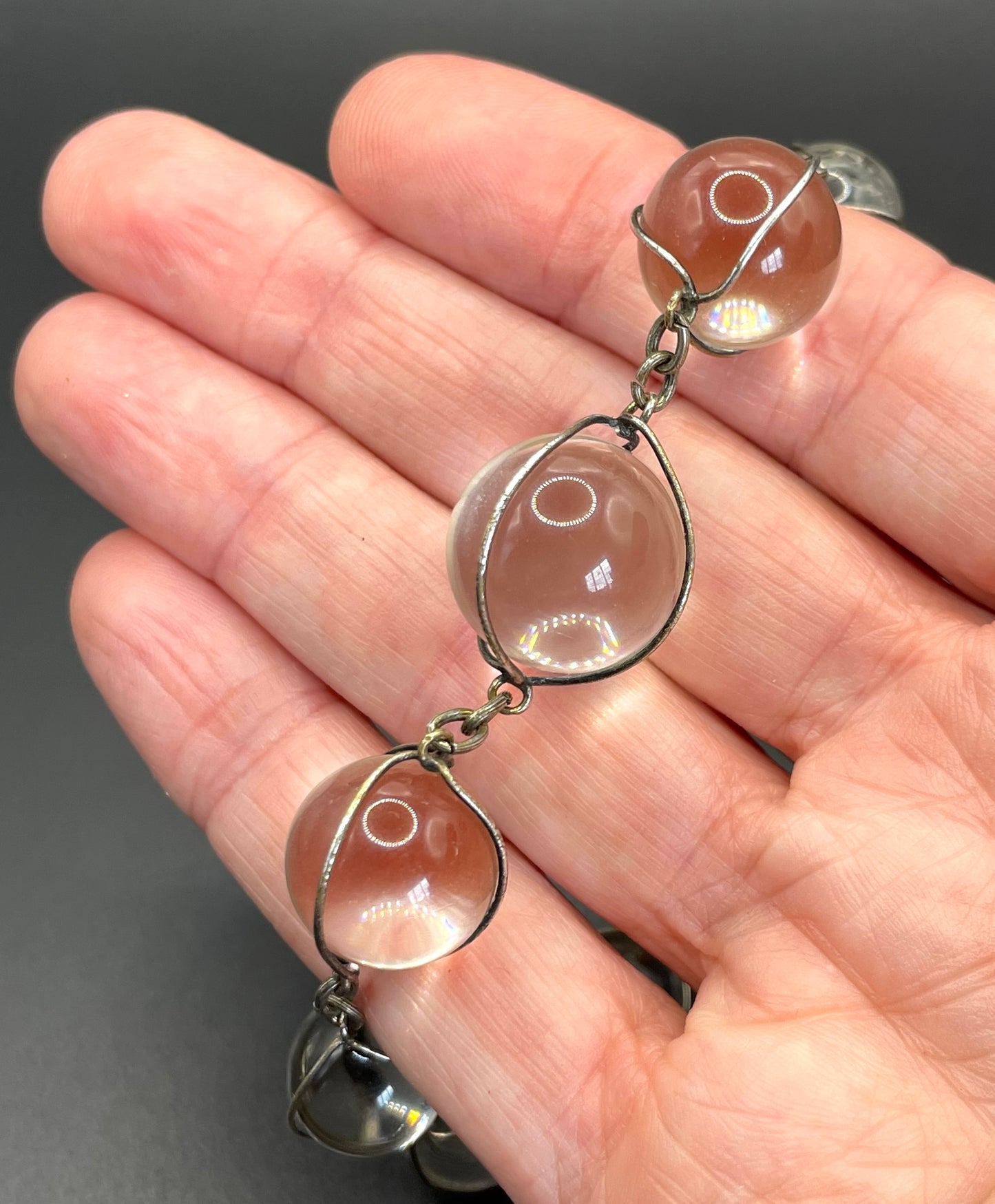 Antique 'pools of light' longer length necklace with undrilled rock crystal orbs in silver tone wire cage settings