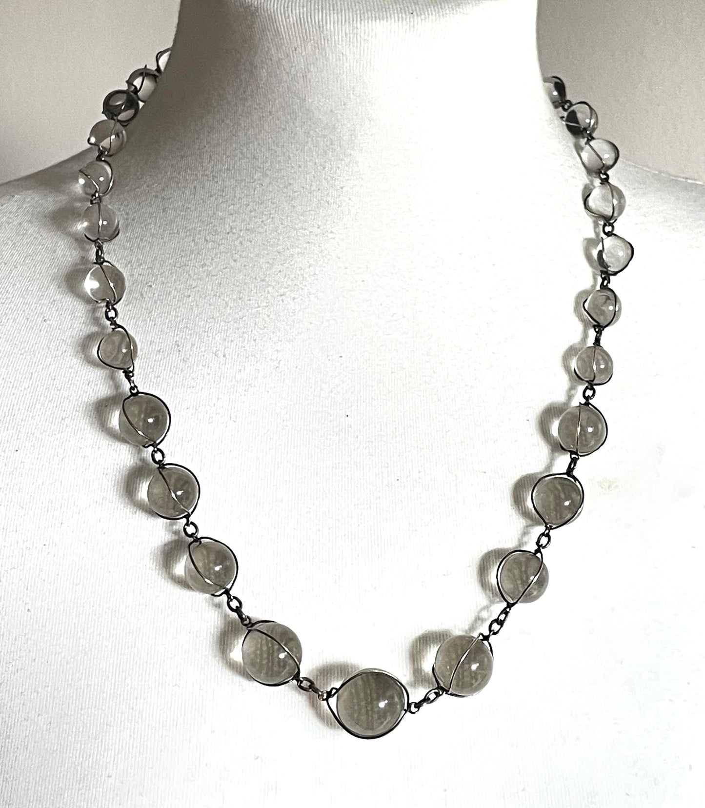 Antique 'pools of light' longer length necklace with undrilled rock crystal orbs in silver tone wire cage settings