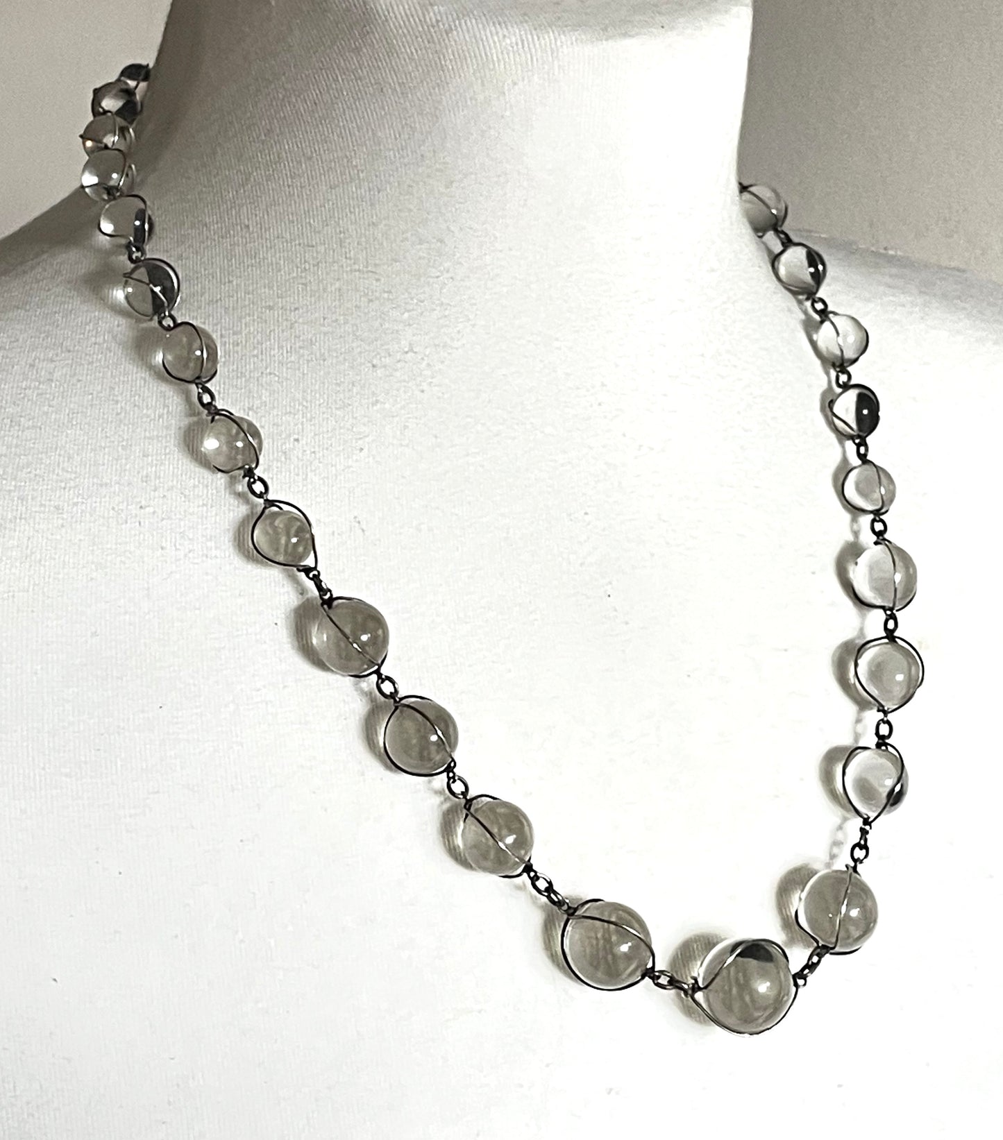 Antique 'pools of light' longer length necklace with undrilled rock crystal orbs in silver tone wire cage settings