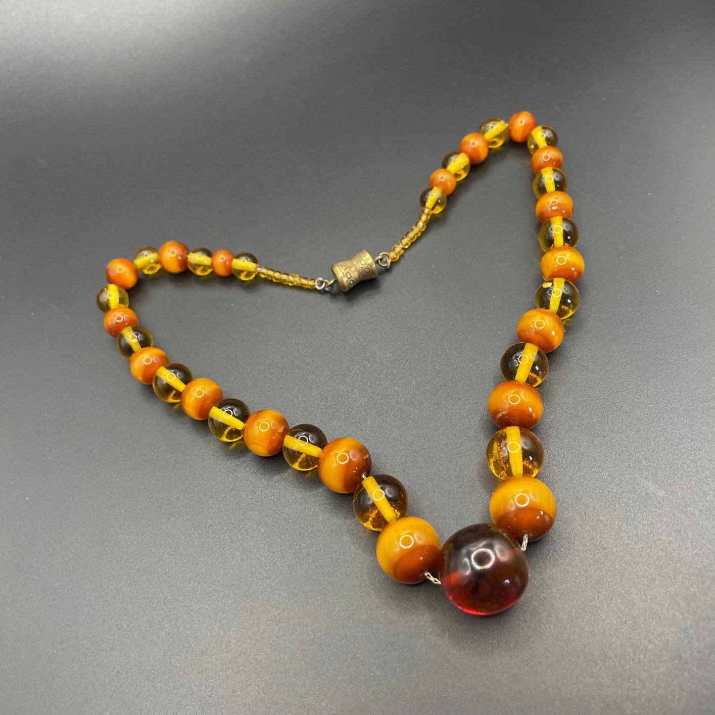 Vintage Louis Rousselet uranium glass Art Deco necklace on foxtail chain - cats' eye UV sensitive and transparent orange beads