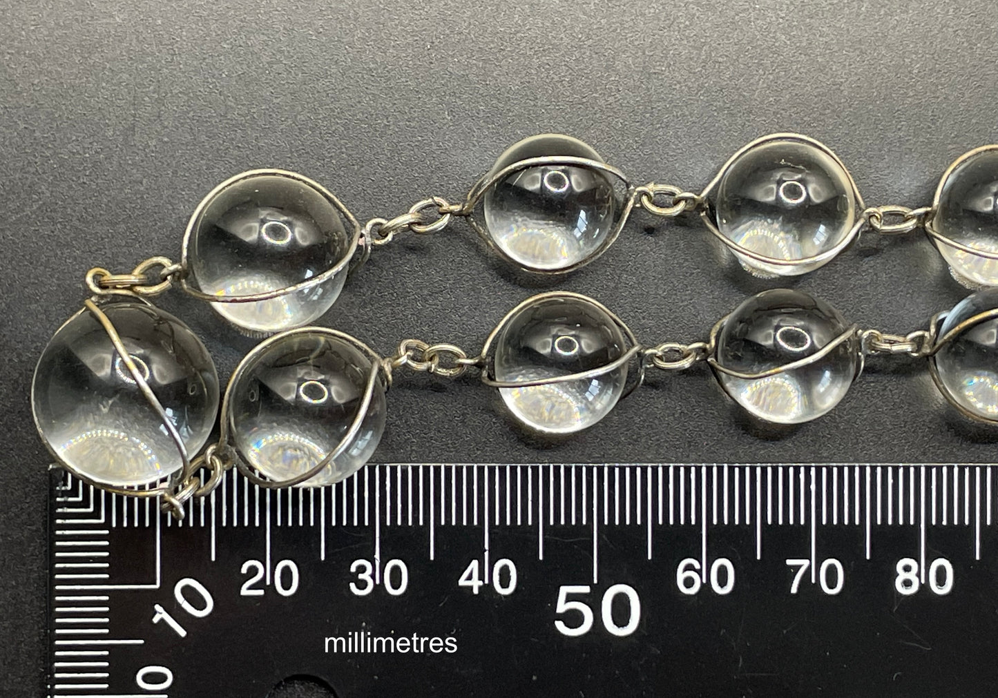 Antique 'pools of light' longer length necklace with undrilled rock crystal orbs in silver tone wire cage settings