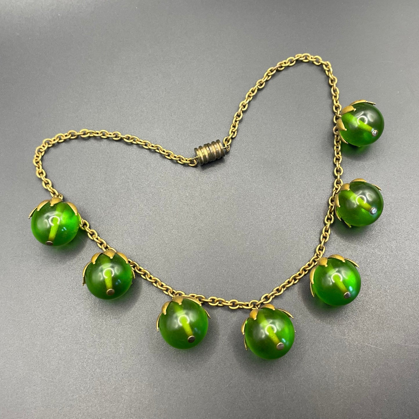 Vintage Art Deco 1930s machine age beaded fringe necklace with early plastic transparent green round chunky beads, antique gold tone links