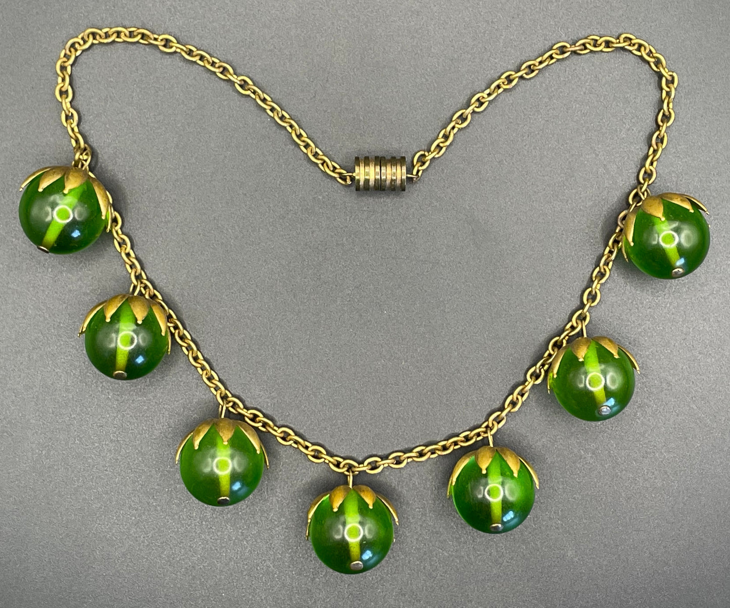 Vintage Art Deco 1930s machine age beaded fringe necklace with early plastic transparent green round chunky beads, antique gold tone links