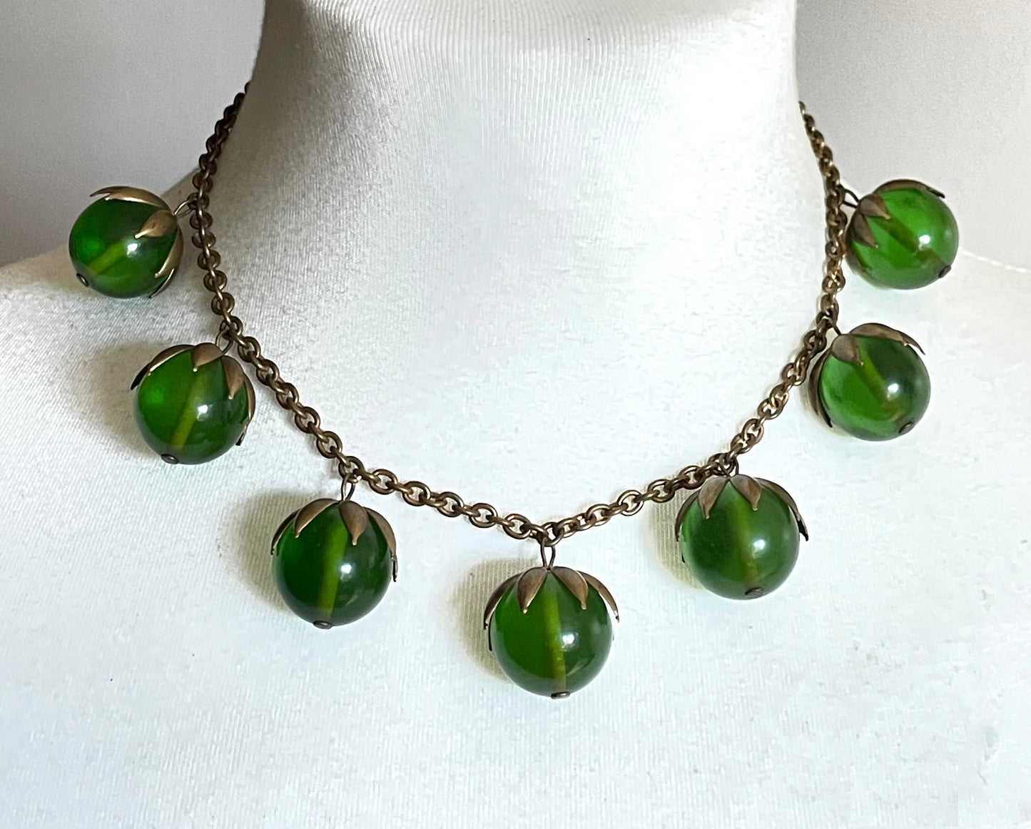 Vintage Art Deco 1930s machine age beaded fringe necklace with early plastic transparent green round chunky beads, antique gold tone links