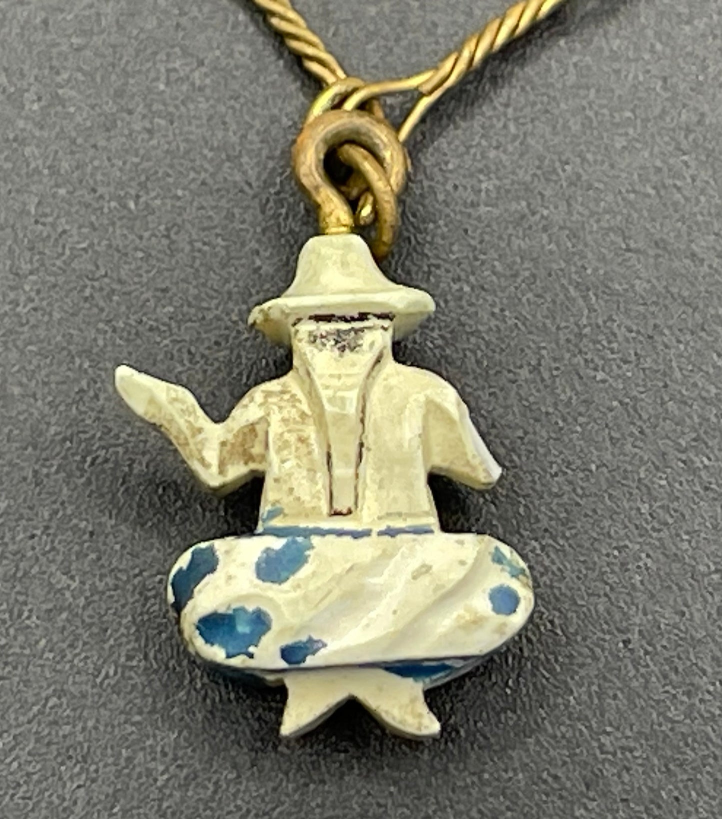 Delicate vintage / antique charm bracelet with slim gold tone chain and four early plastic or carved bone painted cracker charms