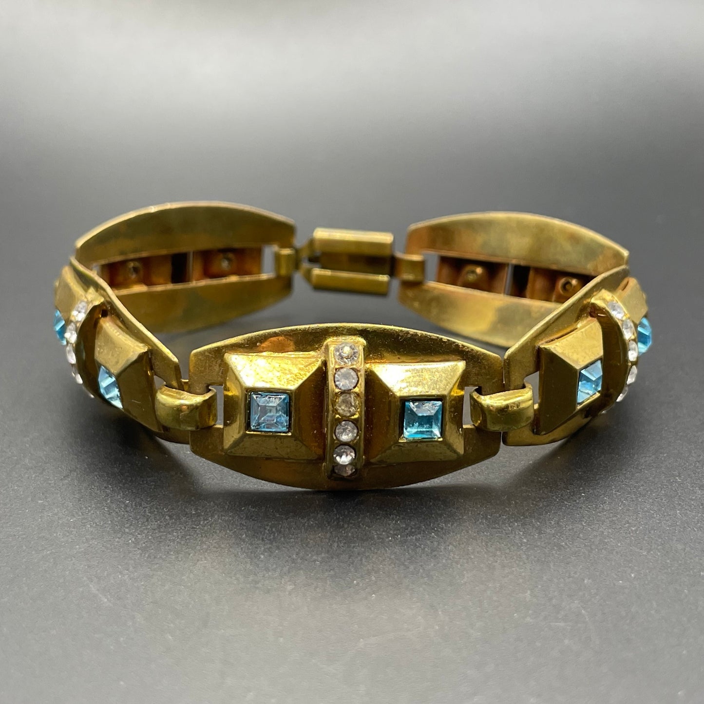 Vintage Art Deco clear and turquoise blue paste rhinestone and gold tone geometric panel bracelet