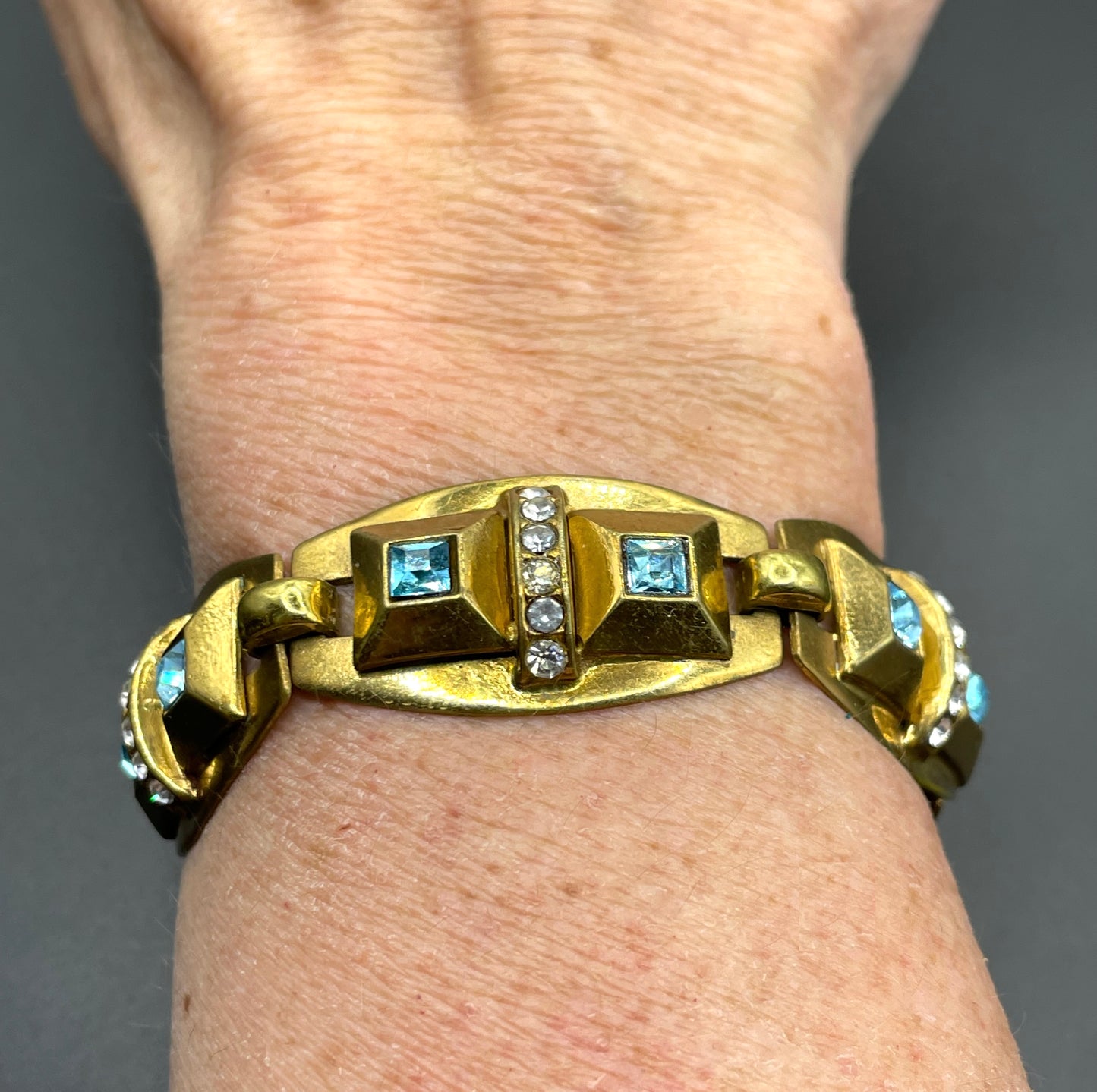 Vintage Art Deco clear and turquoise blue paste rhinestone and gold tone geometric panel bracelet