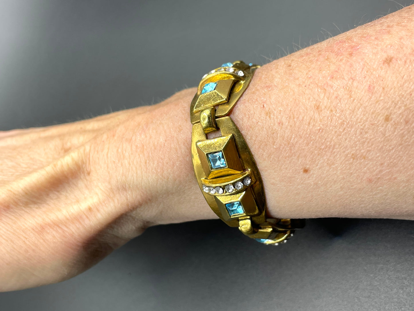 Vintage Art Deco clear and turquoise blue paste rhinestone and gold tone geometric panel bracelet