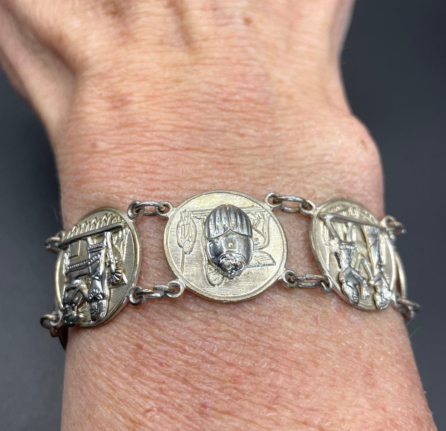 Vintage Egyptian revival scarab, pharaoh and hieroglyphics design silver tone circular panel bracelet, rubbing to silver tone