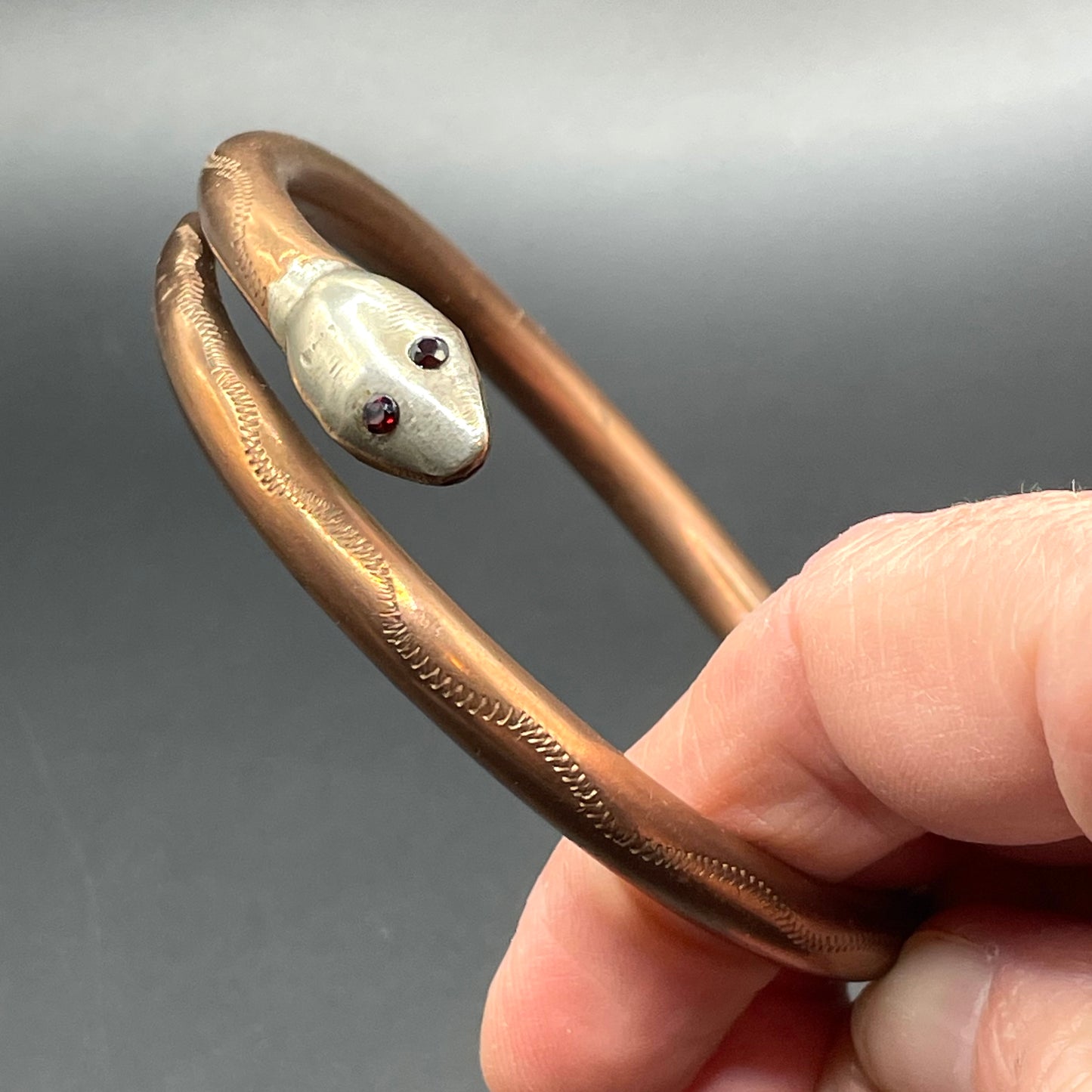 Vintage Art Deco 1920s to 1930s heavy copper snake arm bangle with silver tone head and garnet eyes, pretty hand engraving / tooling