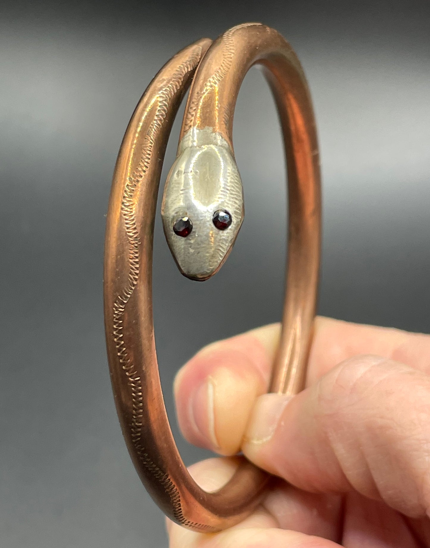 Vintage Art Deco 1920s to 1930s heavy copper snake arm bangle with silver tone head and garnet eyes, pretty hand engraving / tooling