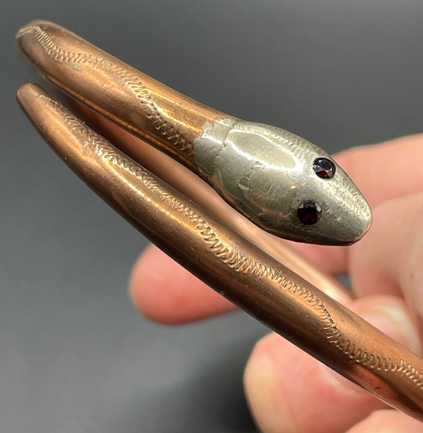 Vintage Art Deco 1920s to 1930s heavy copper snake arm bangle with silver tone head and garnet eyes, pretty hand engraving / tooling
