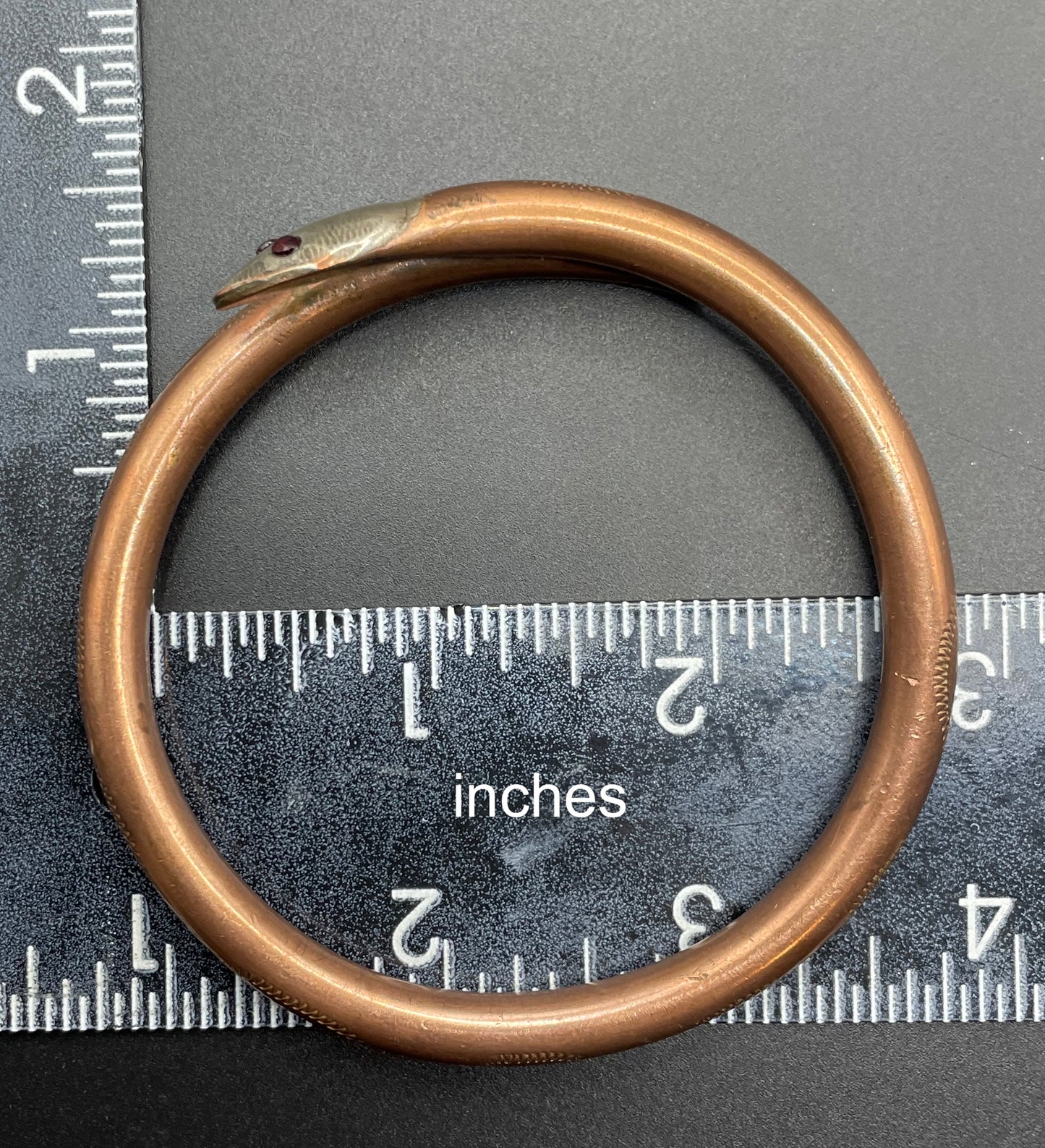 Vintage Art Deco 1920s to 1930s heavy copper snake arm bangle with silver tone head and garnet eyes, pretty hand engraving / tooling