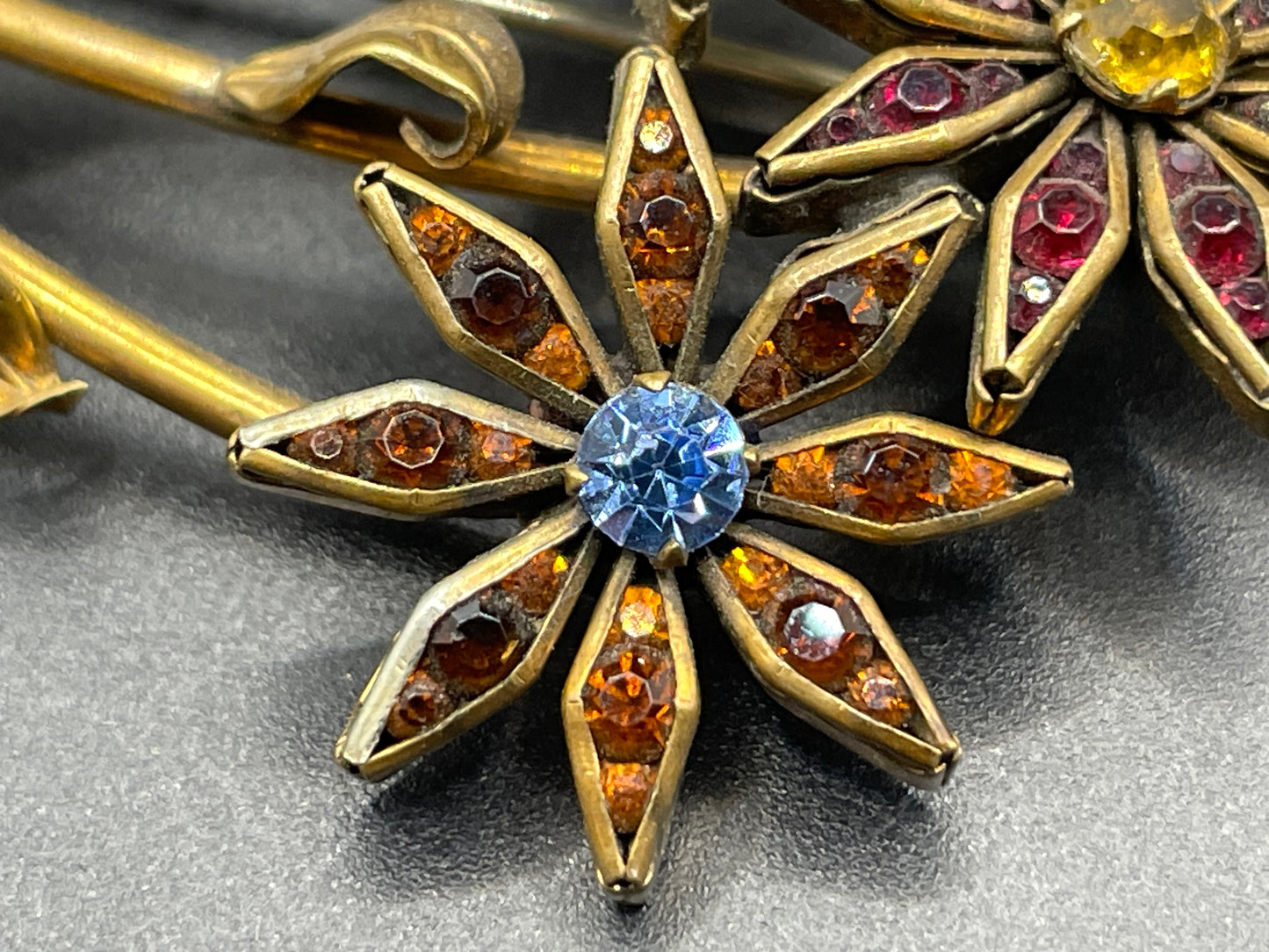 Vintage Schreiber & Hiller (unsigned) flower brooch, Art Deco channel set red, pink, orange, yellow, blue and clear paste rhinestones