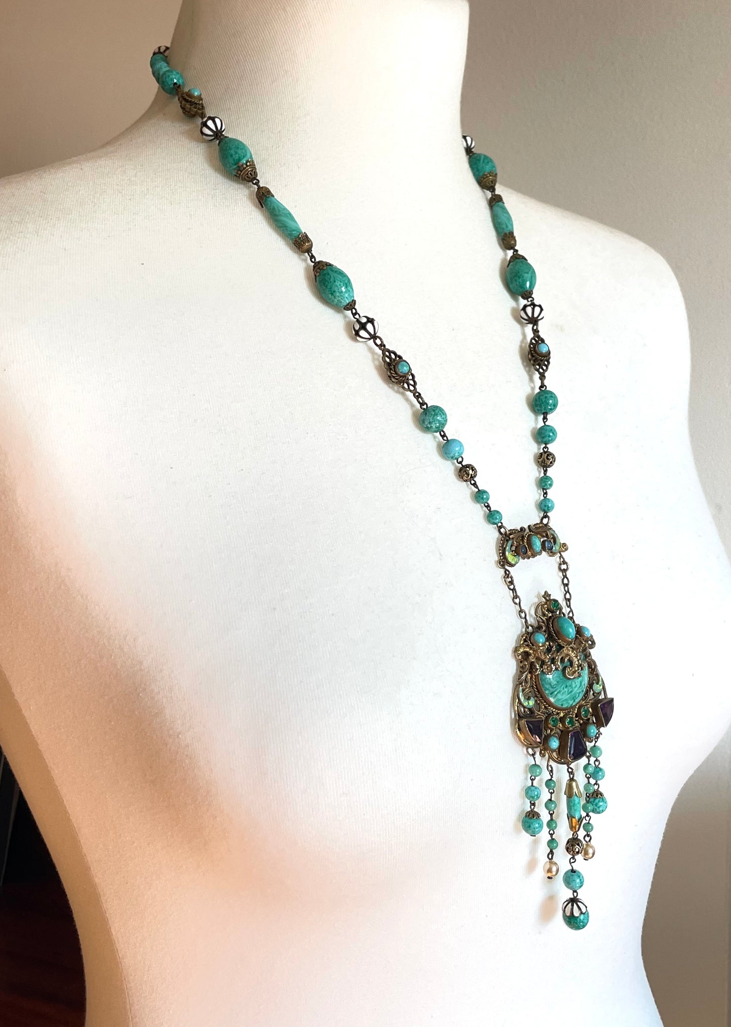 Vintage Neiger brothers long flapper necklace with ornate beads, enamel and lariat panels, green 'Peking' glass, green & purple rhinestones