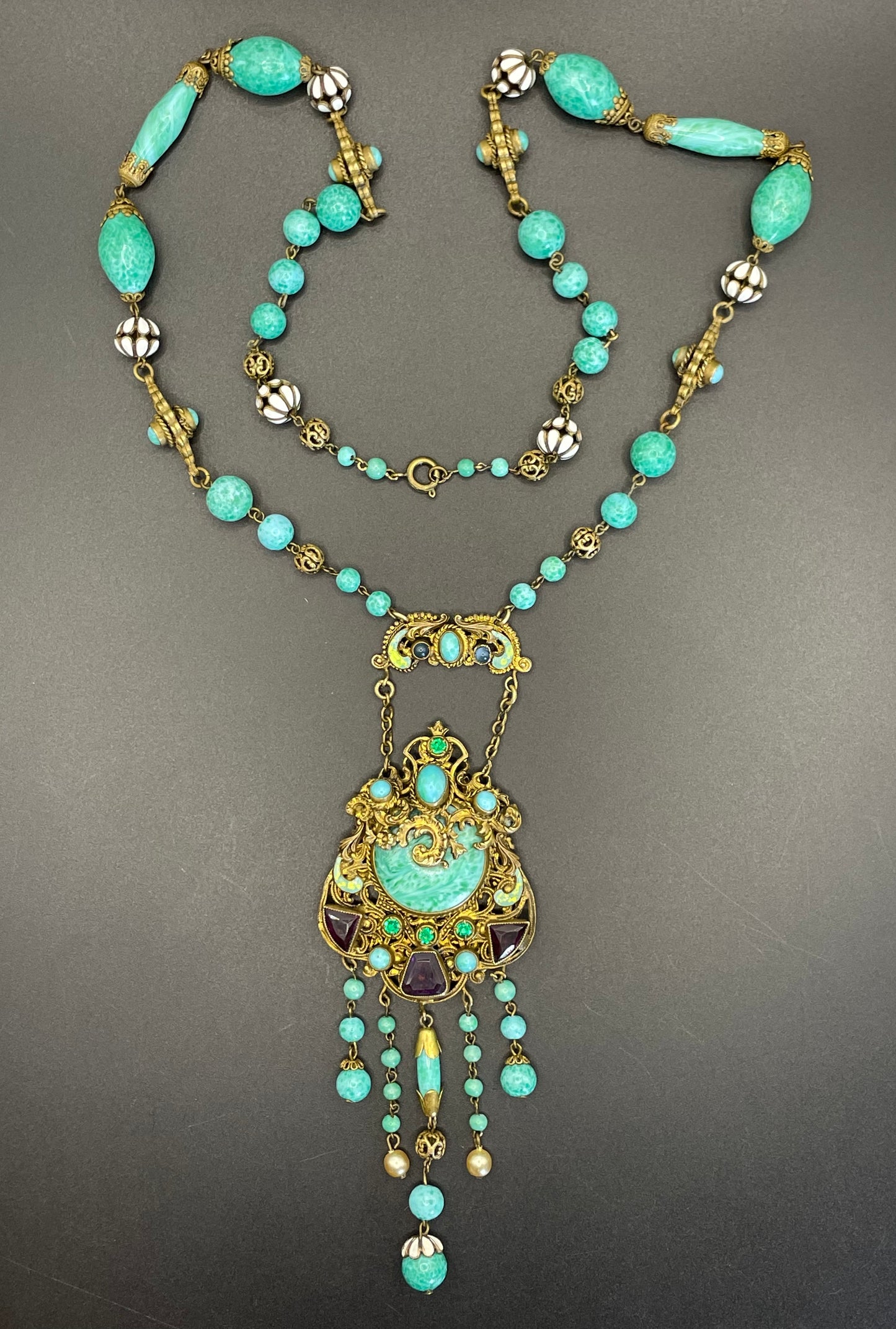 Vintage Neiger brothers long flapper necklace with ornate beads, enamel and lariat panels, green 'Peking' glass, green & purple rhinestones