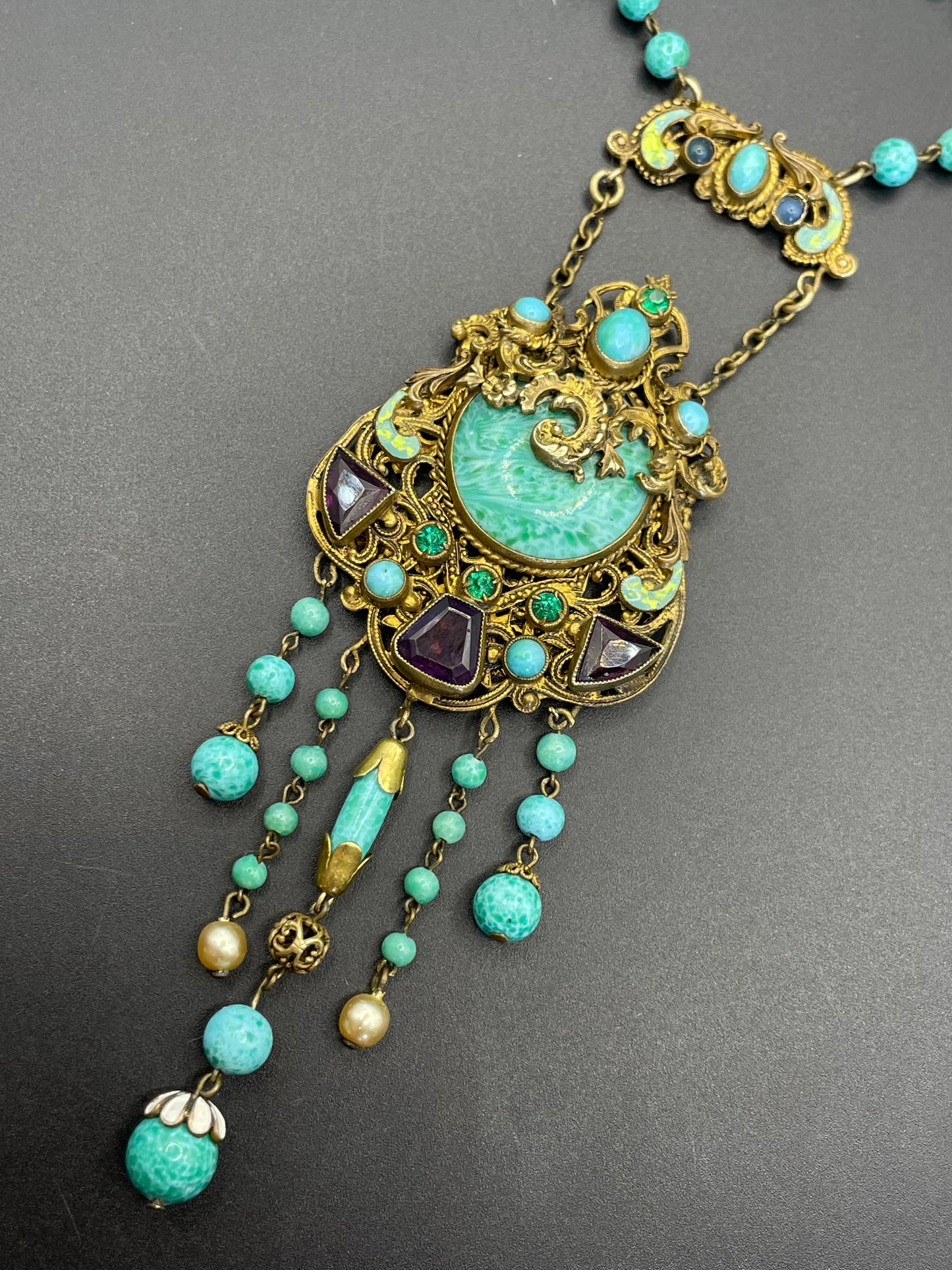 Vintage Neiger brothers long flapper necklace with ornate beads, enamel and lariat panels, green 'Peking' glass, green & purple rhinestones