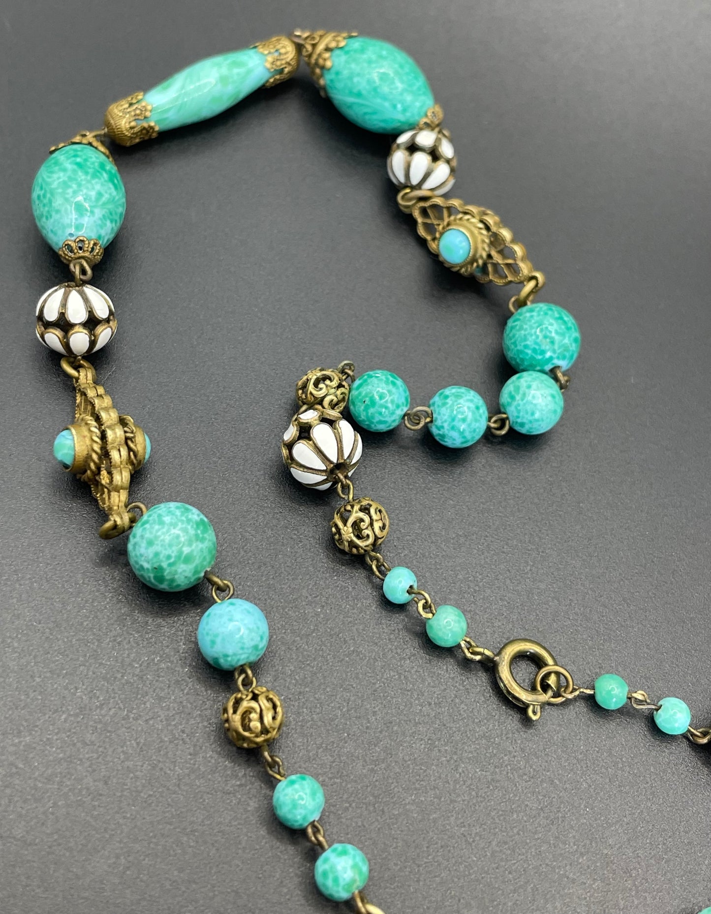 Vintage Neiger brothers long flapper necklace with ornate beads, enamel and lariat panels, green 'Peking' glass, green & purple rhinestones