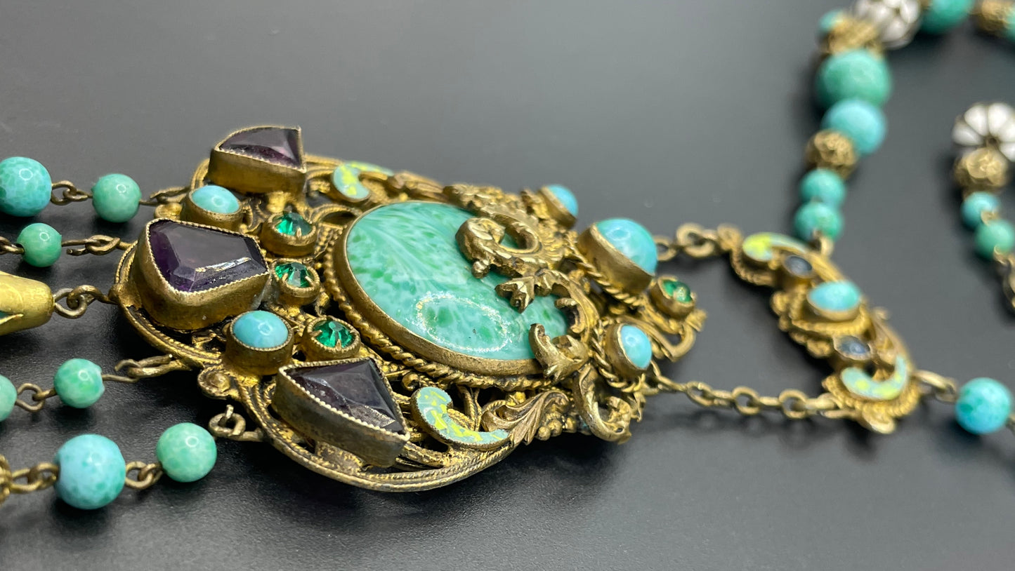 Vintage Neiger brothers long flapper necklace with ornate beads, enamel and lariat panels, green 'Peking' glass, green & purple rhinestones