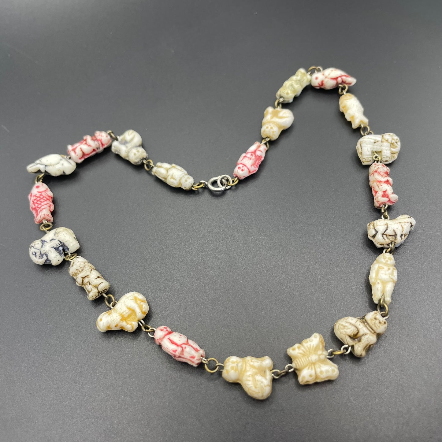 Vintage moulded 'custard' glass animal, bird, butterfly, fish & people shaped beaded necklace, rare Czech pressed glass with UV sensitivity