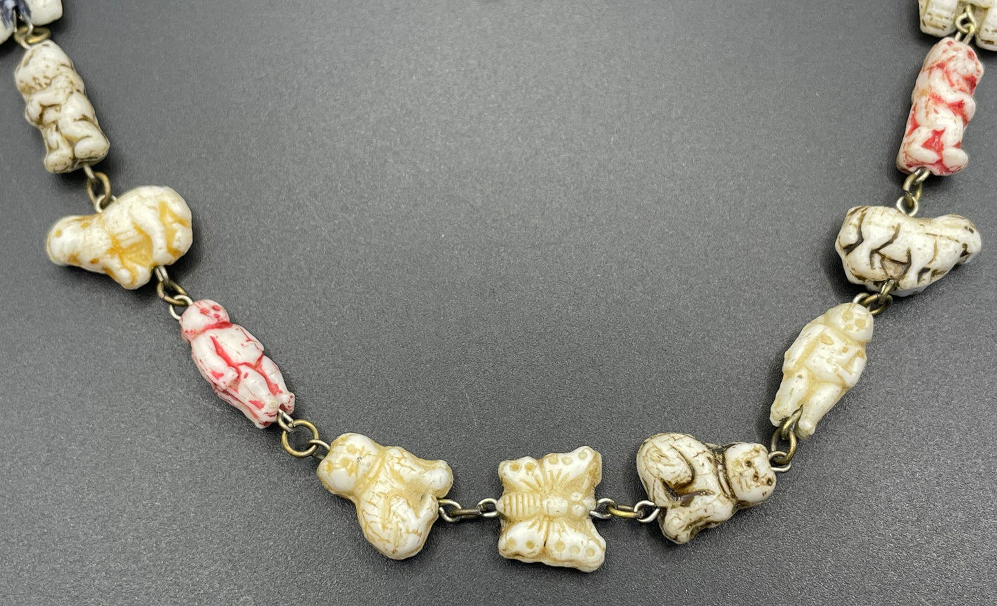 Vintage moulded 'custard' glass animal, bird, butterfly, fish & people shaped beaded necklace, rare Czech pressed glass with UV sensitivity
