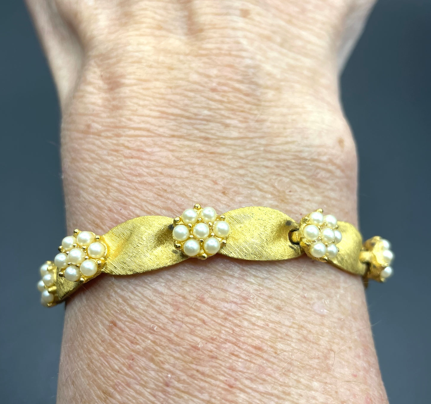 Vintage signed Trifari classic gold plated with faux pearls birthday series ribbon daisy flower panel bracelet