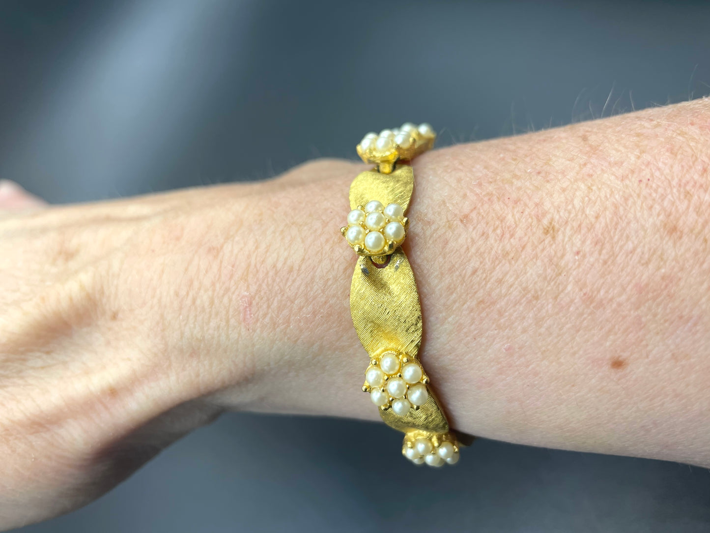 Vintage signed Trifari classic gold plated with faux pearls birthday series ribbon daisy flower panel bracelet