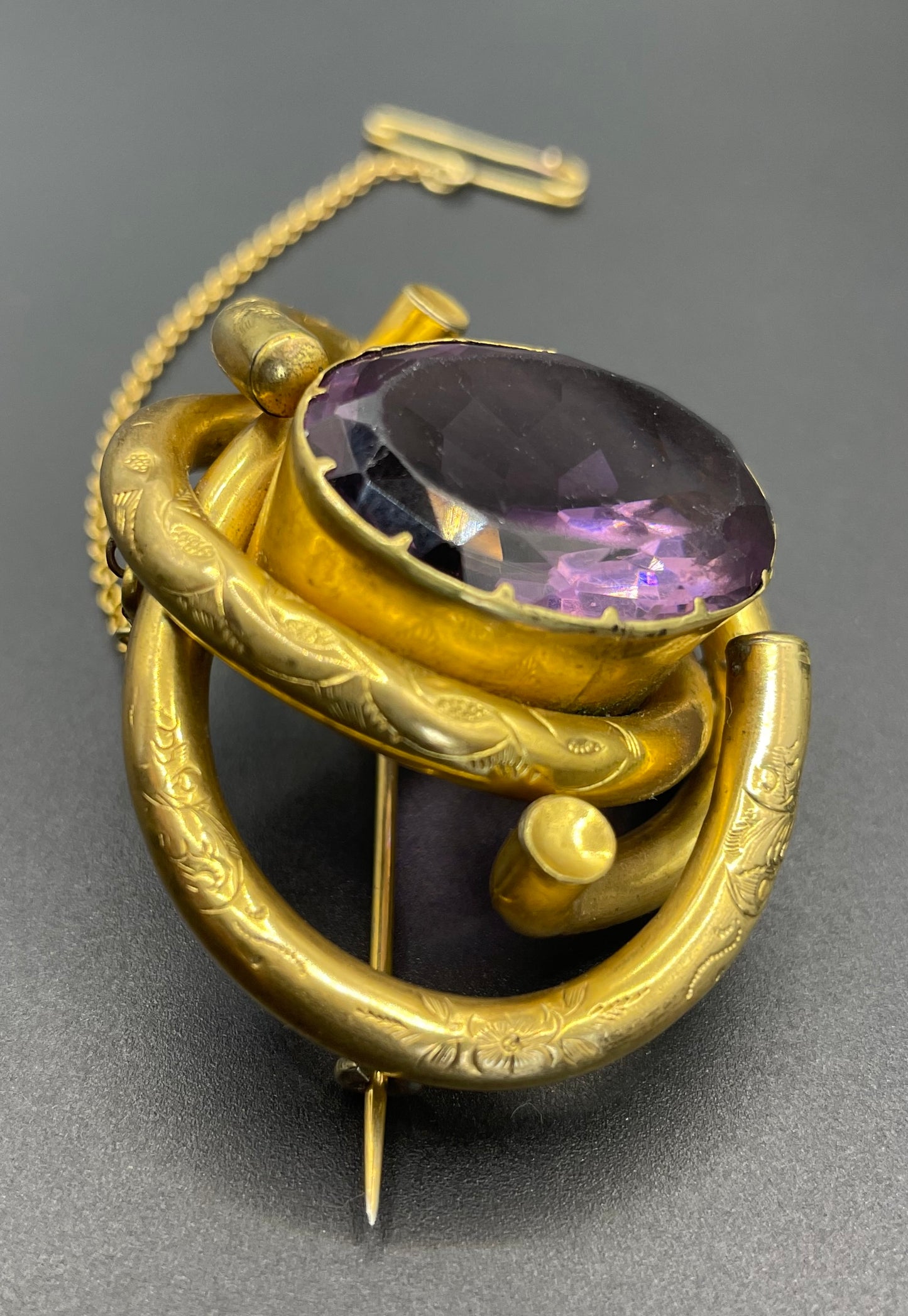 Antique Victorian Scottish chased pinchbeck or gold filled / rolled gold large love knot brooch with large purple paste rhinestone