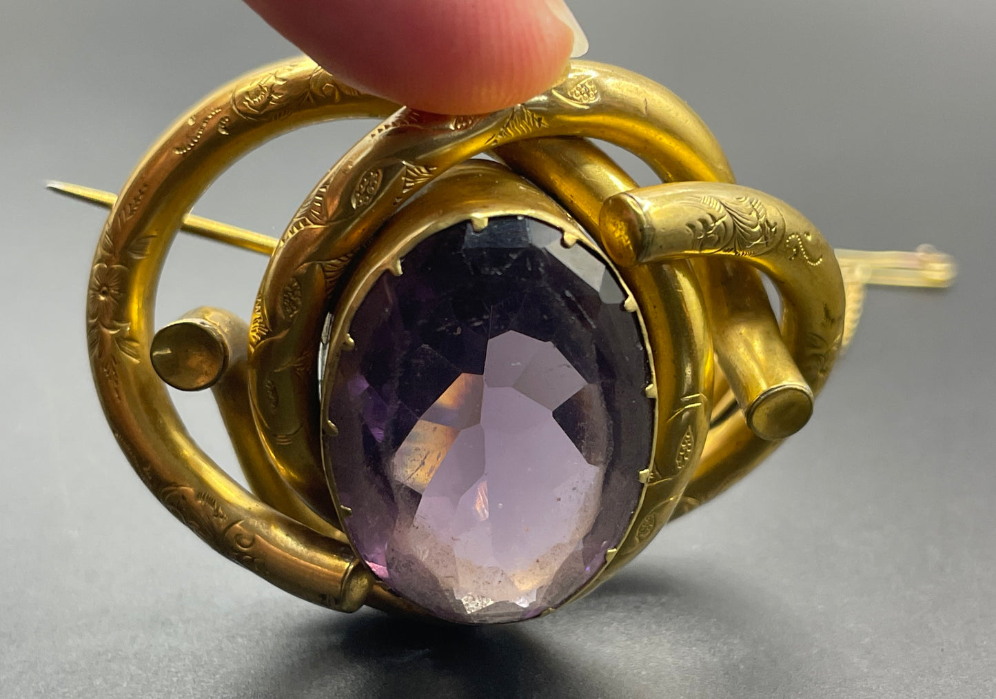 Antique Victorian Scottish chased pinchbeck or gold filled / rolled gold large love knot brooch with large purple paste rhinestone
