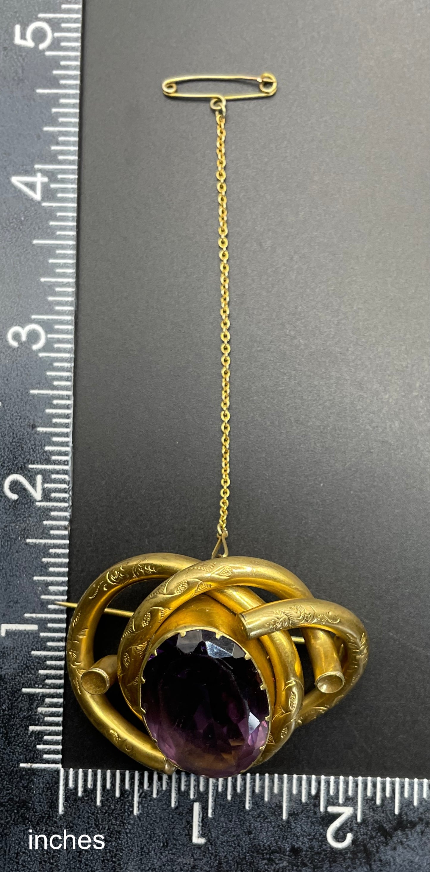 Antique Victorian Scottish chased pinchbeck or gold filled / rolled gold large love knot brooch with large purple paste rhinestone