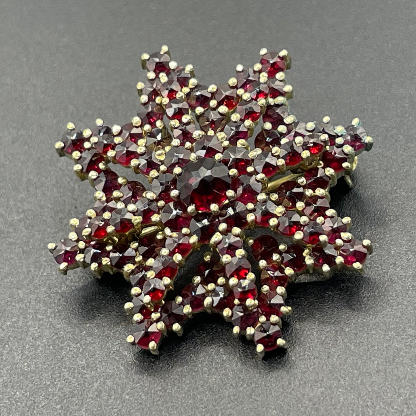 Vintage / antique Bohemian garnet floral star shaped brooch, rose cut stones set in gold tone, possibly gold, gold plated or tombac