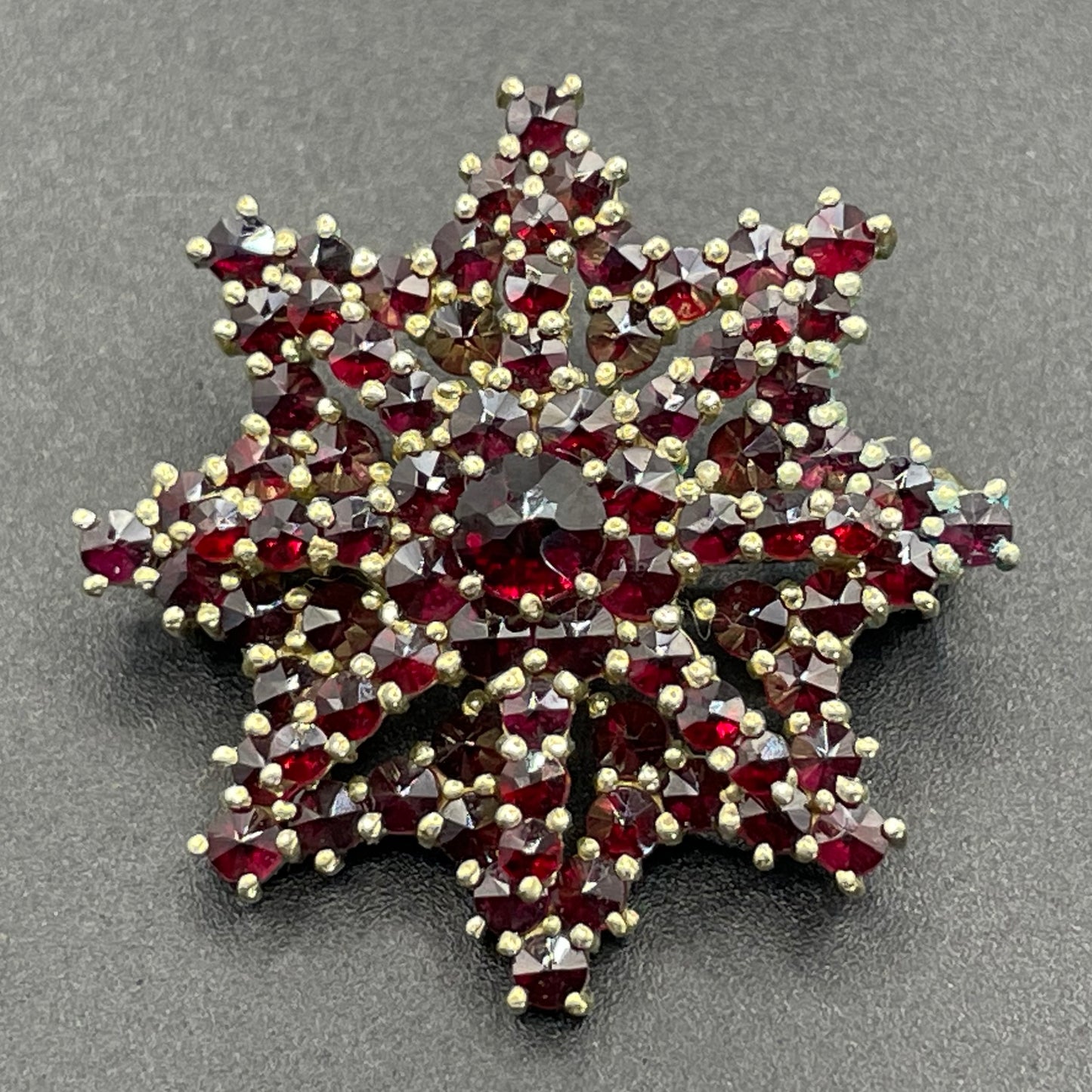Vintage / antique Bohemian garnet floral star shaped brooch, rose cut stones set in gold tone, possibly gold, gold plated or tombac