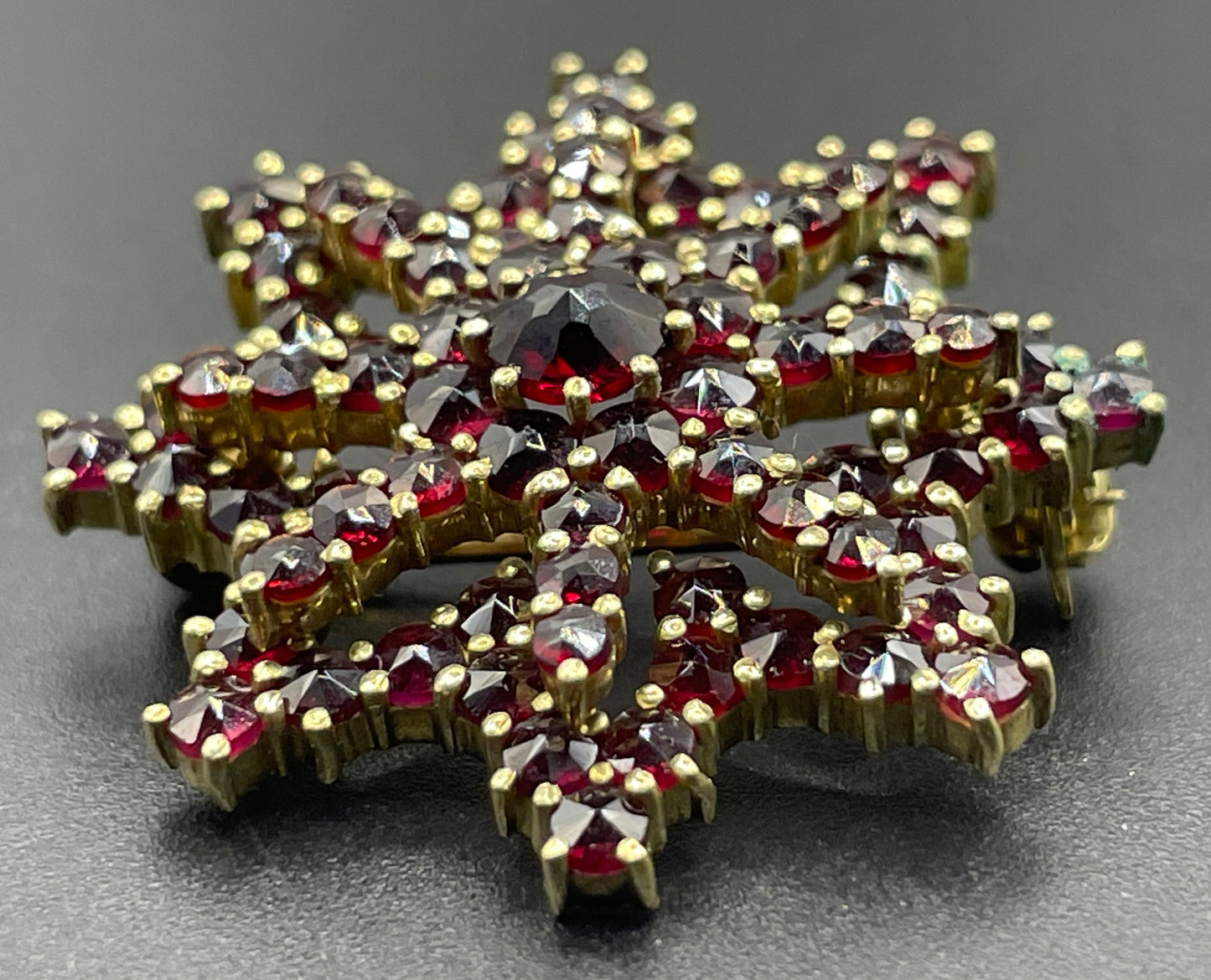 Vintage / antique Bohemian garnet floral star shaped brooch, rose cut stones set in gold tone, possibly gold, gold plated or tombac