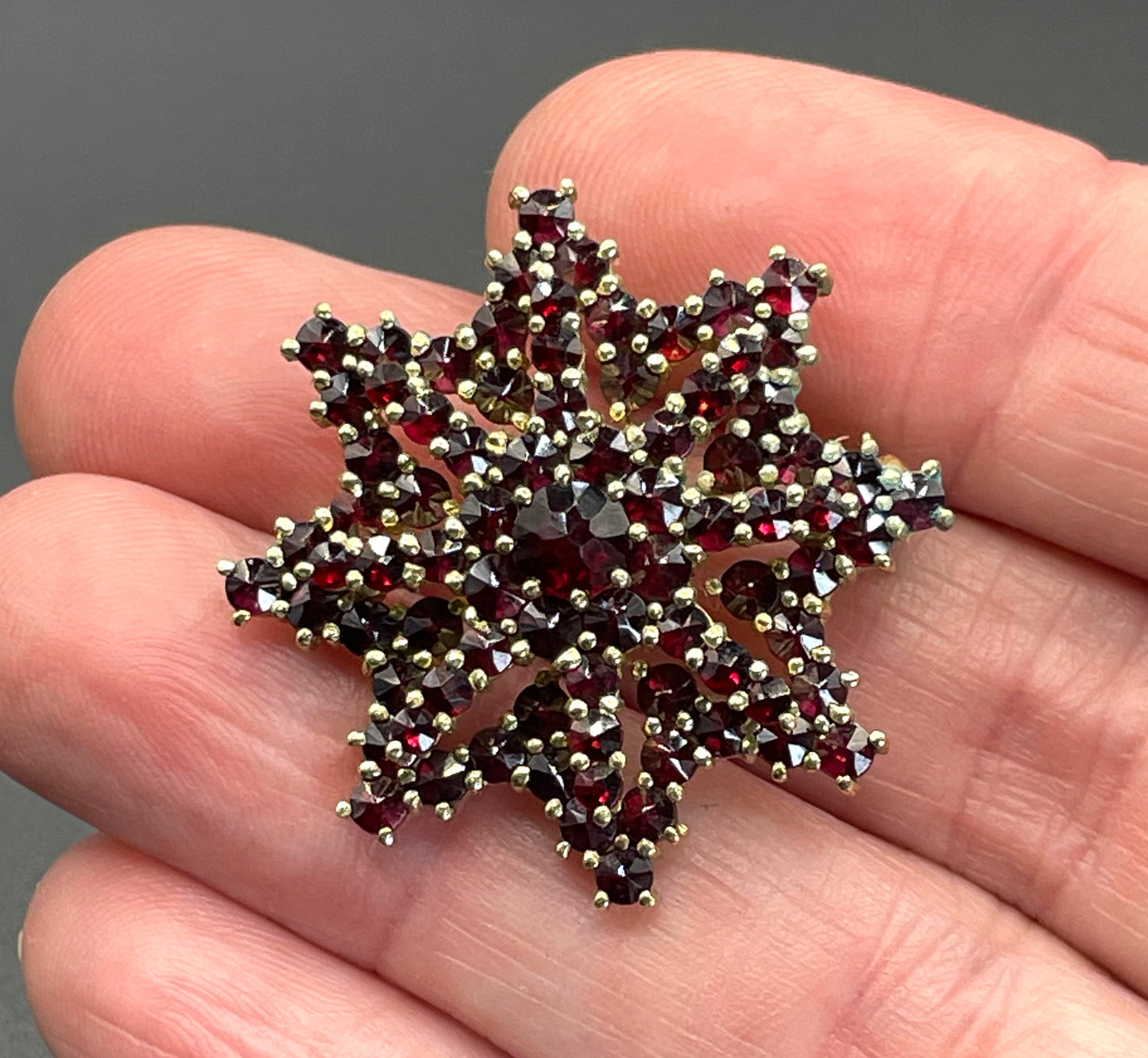 Vintage / antique Bohemian garnet floral star shaped brooch, rose cut stones set in gold tone, possibly gold, gold plated or tombac