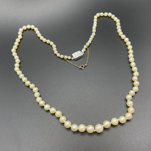 Vintage real cultured pearl necklace, graduated in size, hand-knotted, pretty engraved sterling silver clasp, mid-length