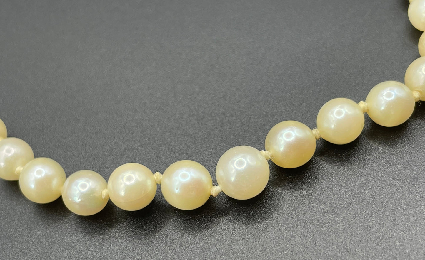 Vintage real cultured pearl necklace, graduated in size, hand-knotted, pretty engraved sterling silver clasp, mid-length