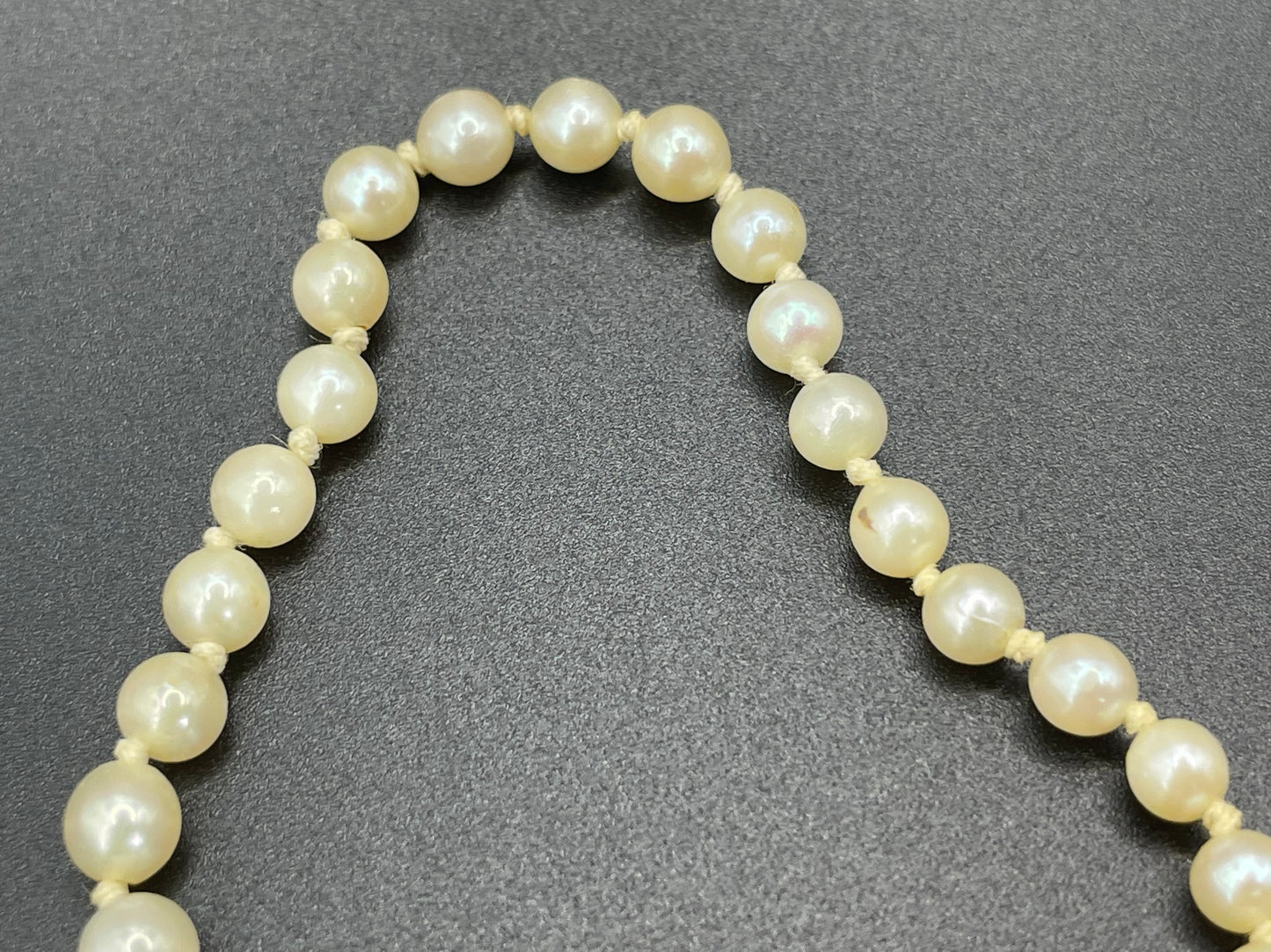 Vintage real cultured pearl necklace, graduated in size, hand-knotted, pretty engraved sterling silver clasp, mid-length