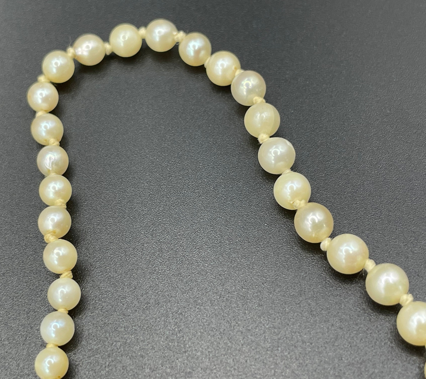 Vintage real cultured pearl necklace, graduated in size, hand-knotted, pretty engraved sterling silver clasp, mid-length