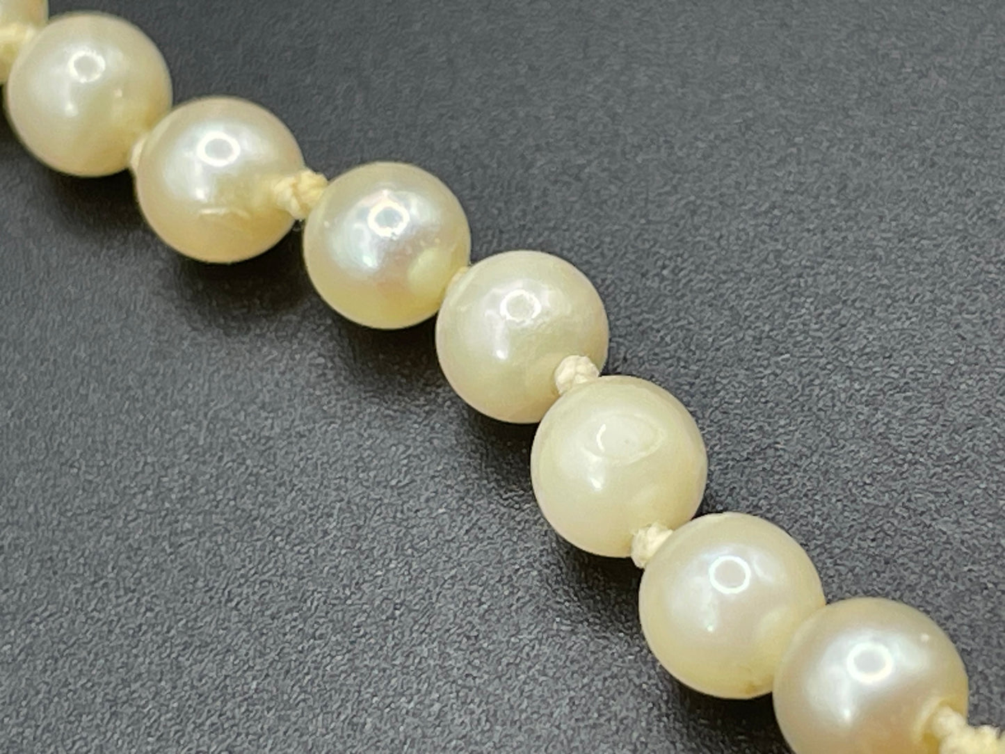 Vintage real cultured pearl necklace, graduated in size, hand-knotted, pretty engraved sterling silver clasp, mid-length