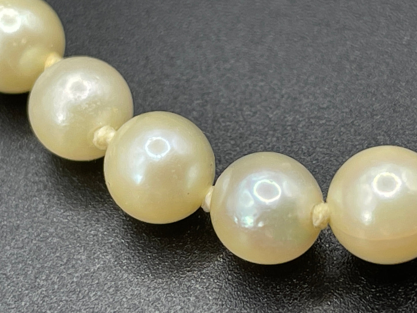 Vintage real cultured pearl necklace, graduated in size, hand-knotted, pretty engraved sterling silver clasp, mid-length