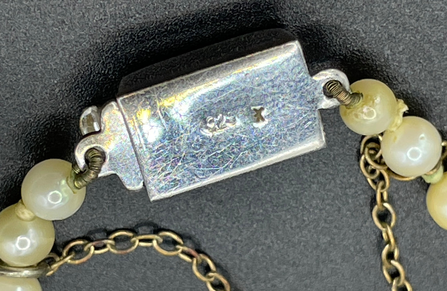 Vintage real cultured pearl necklace, graduated in size, hand-knotted, pretty engraved sterling silver clasp, mid-length