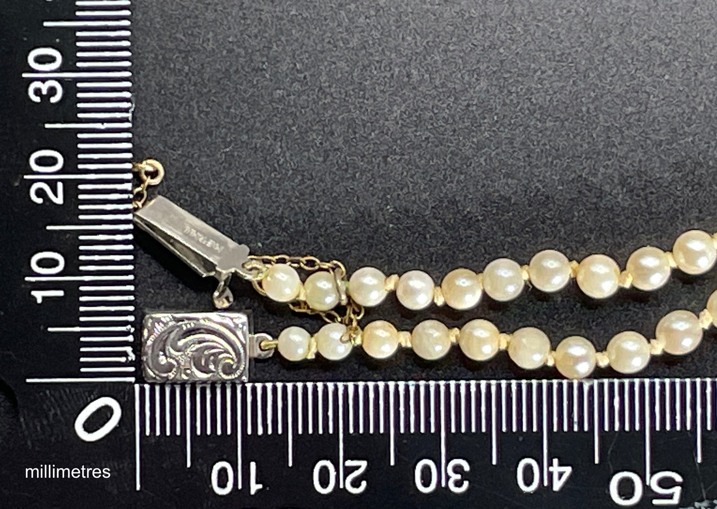 Vintage real cultured pearl necklace, graduated in size, hand-knotted, pretty engraved sterling silver clasp, mid-length